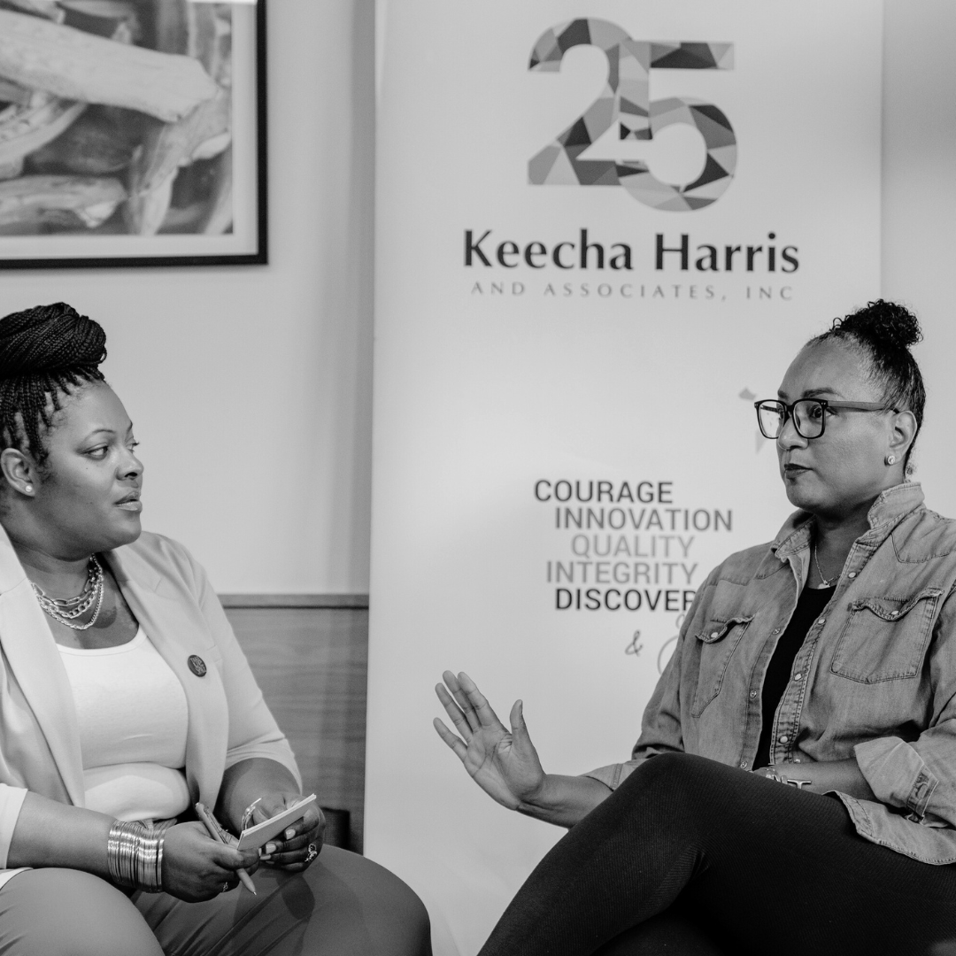 Keecha Harris & Associates team members sitting down in chairs having a discussion