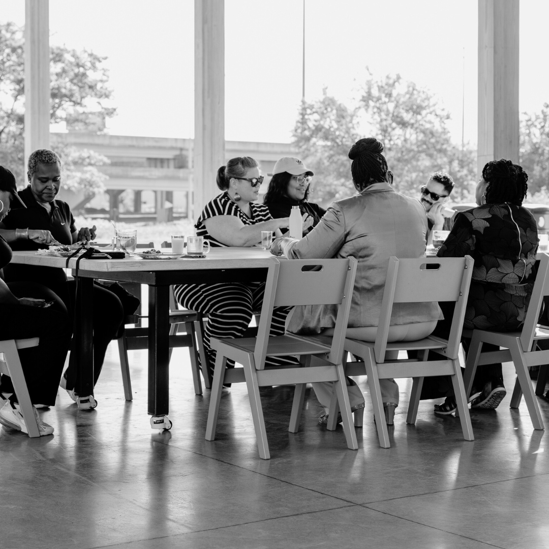 Keecha Harris team sitting at a table having a discussion